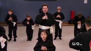 Shawn practices Wu-Shu with other students, ages 5-8.