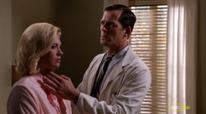 A doctor feels Betty's neck for lumps.